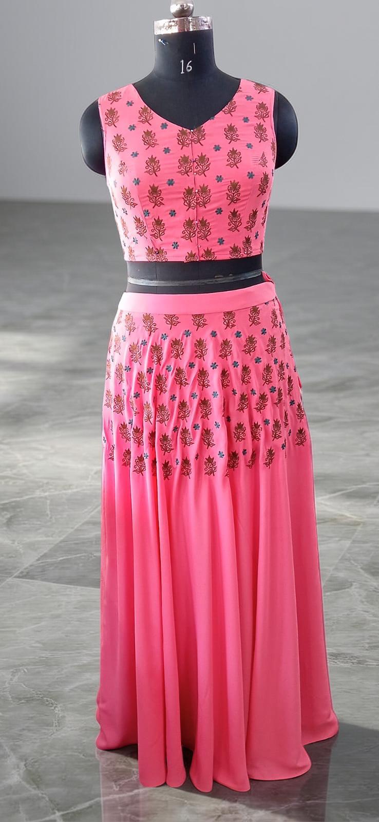 TWO PIECE SALMON COLOR EMBROIDERED LAHENGA SET .